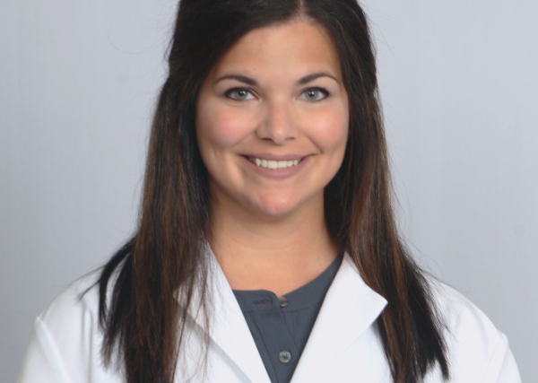 Anna Evans, a registered pharmacist, smiles while wearing her Express Scripts® Pharmacy lab coat.