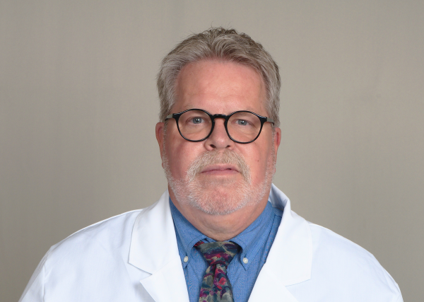 Headshot of Verne Mounts, a registered pharmacist with Express Scripts® Pharmacy, in his lab coat.