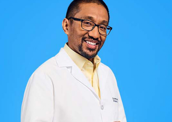 An Express Scripts® Pharmacy pharmacist holds a tablet.