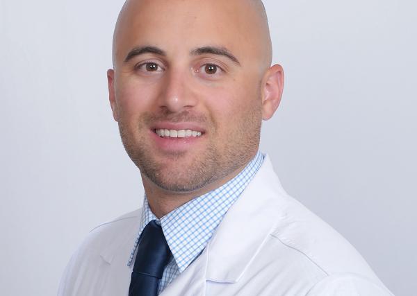 Mike Martinelli, a registered pharmacist with Express Scripts® Pharmacy, in his lab coat.