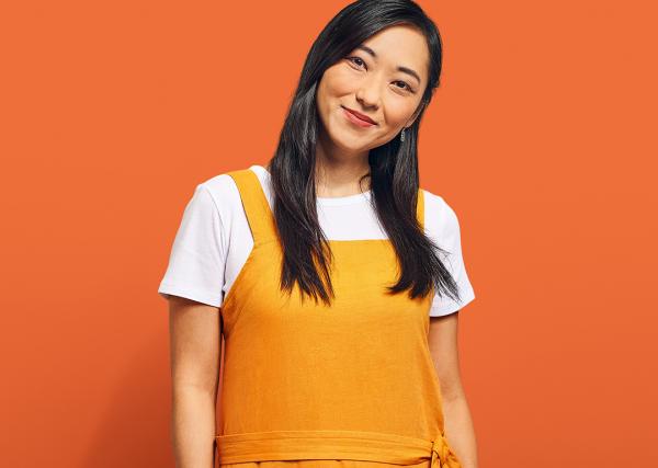 A young woman smiles, looking confident.