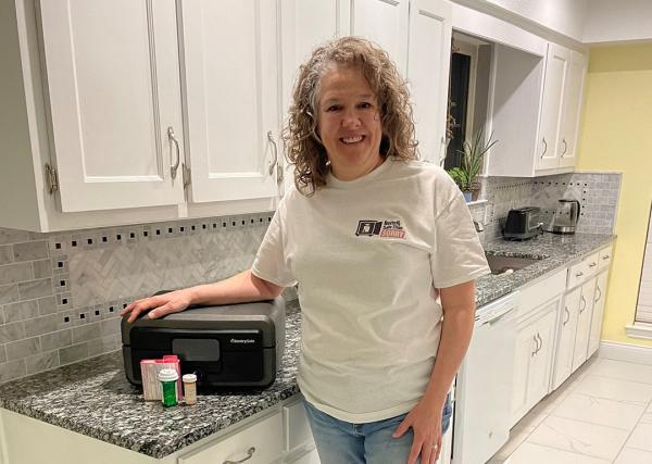 Express Scripts employee Leslie Martin with her biometric safe, where she keeps all of her medication.