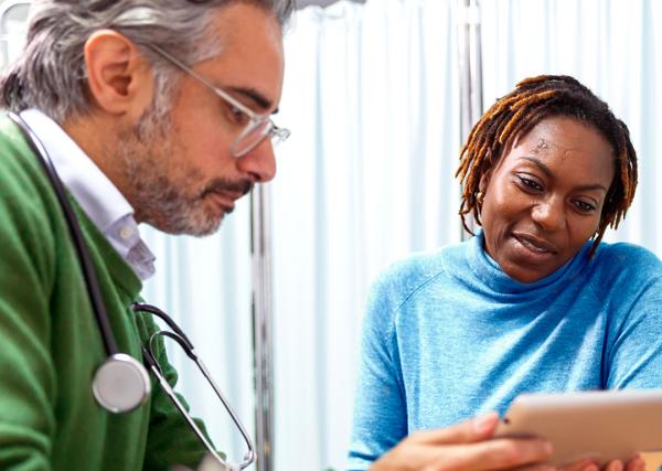 A woman with diabetes goes over her kidney function test results with her doctor.