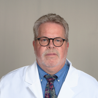 Headshot of Verne Mounts, a registered pharmacist with Express Scripts® Pharmacy, in his lab coat.