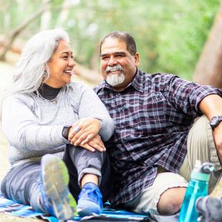 A couple chats while sitting outside in nature